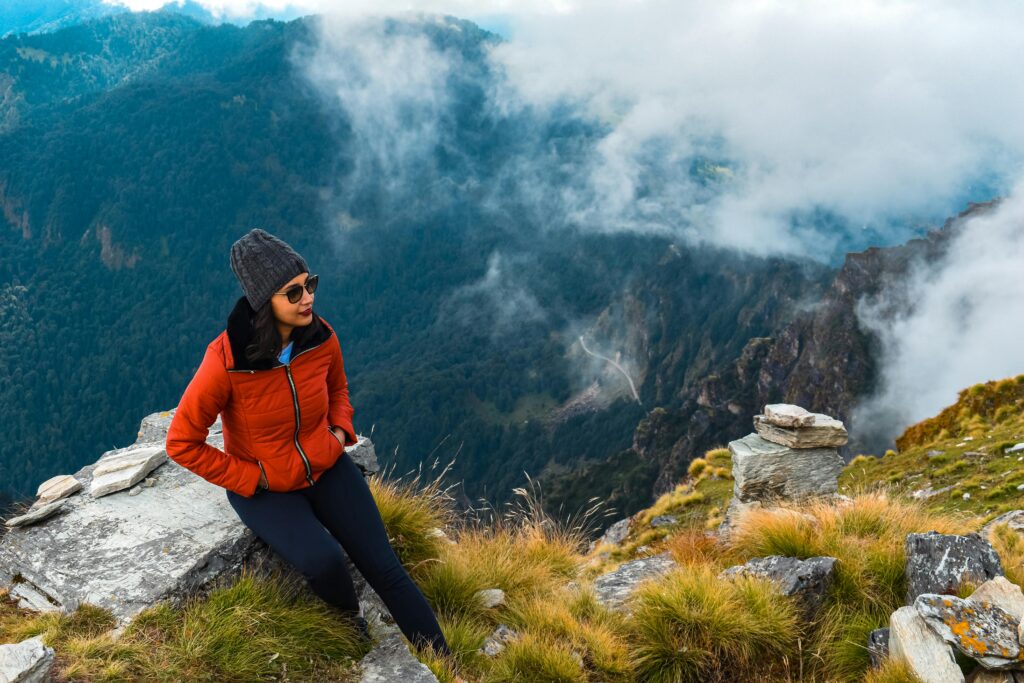 pexels-photo-16915454-16915454 Woman enjoys a break while hiking in the picturesque Chopta mountains, India.