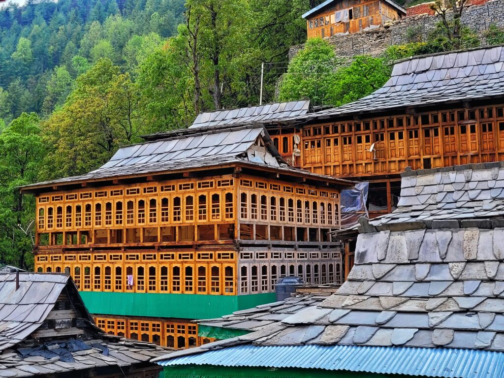 pexels-photo-26202865-26202865 Charming wooden structures in a quaint Himachal Pradesh village surrounded by lush greenery.