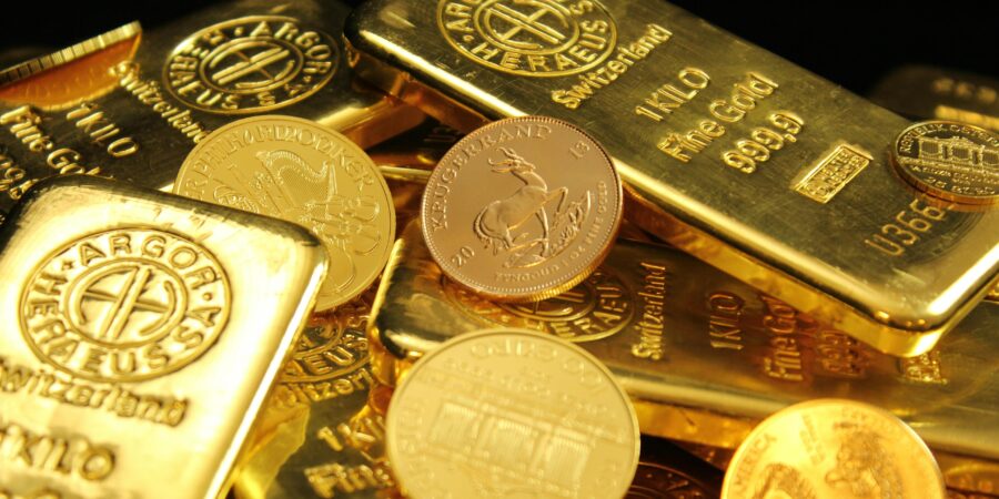 A detailed image of gold bars and coins symbolizing wealth and financial investment.